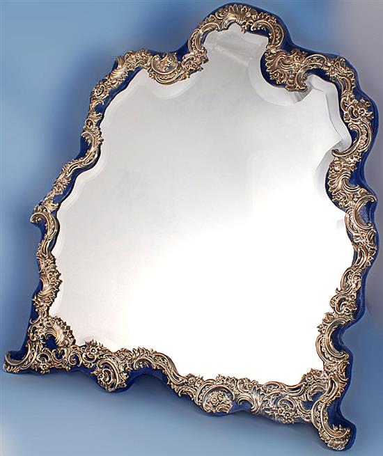 A large George V repousse silver mounted dressing table easel mirror height 24”/610mm width 21 ¾”/552mm.